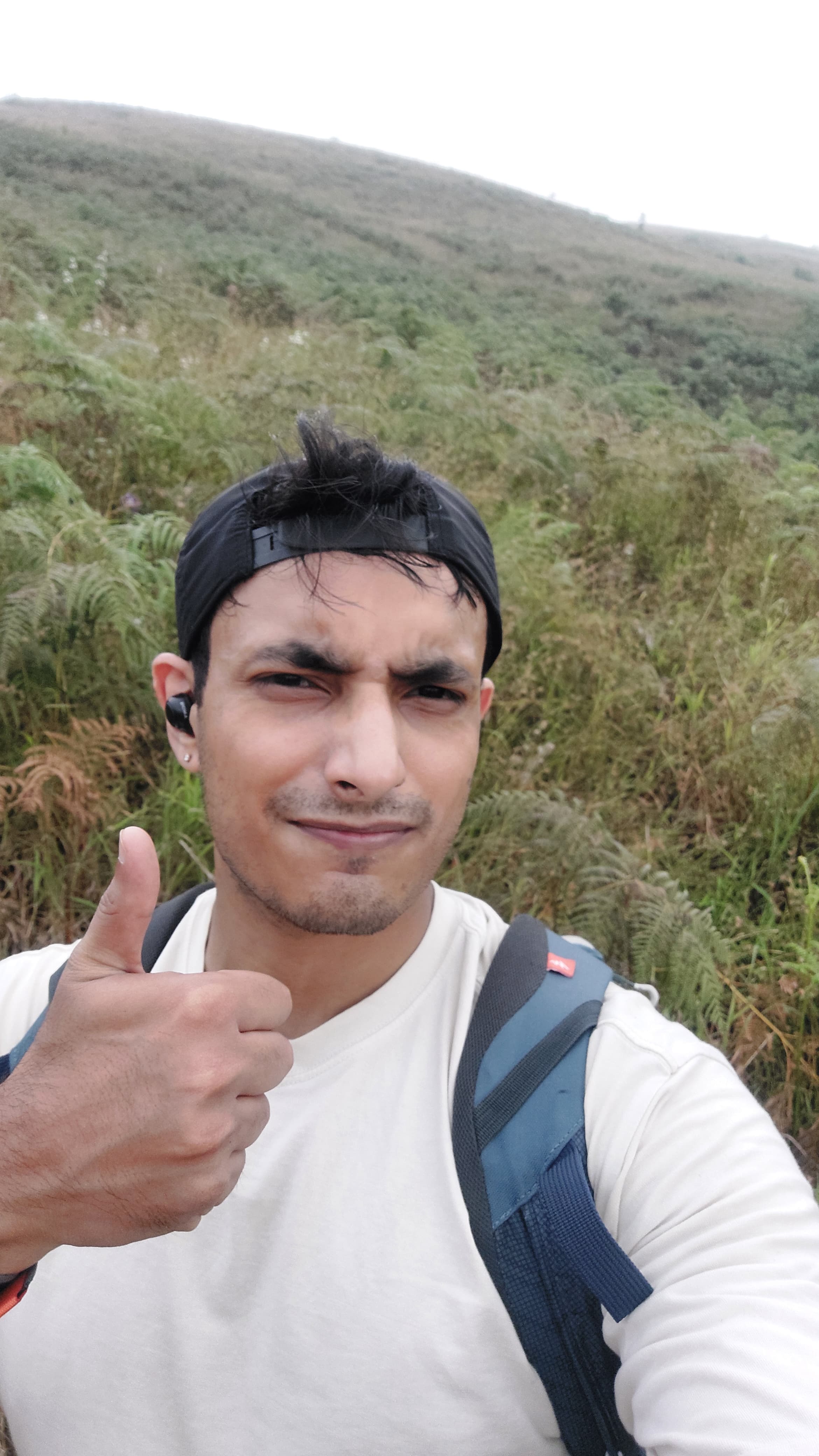 Mohit Saini hiking outdoors and giving a thumbs-up